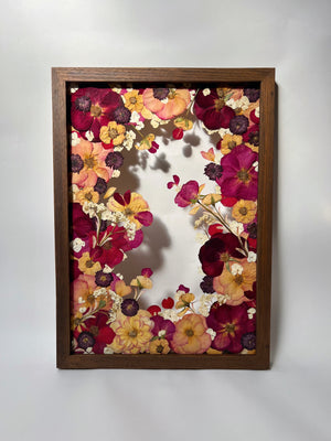 Dark framed deep toned floral artwork made with pressed flowers from a wedding bouquet. A2 large preservation frame with pops of colour. Pressed roses, pressed hydrangeas and chrysanthemums. Australian pressed flower artist old leaf designs creation