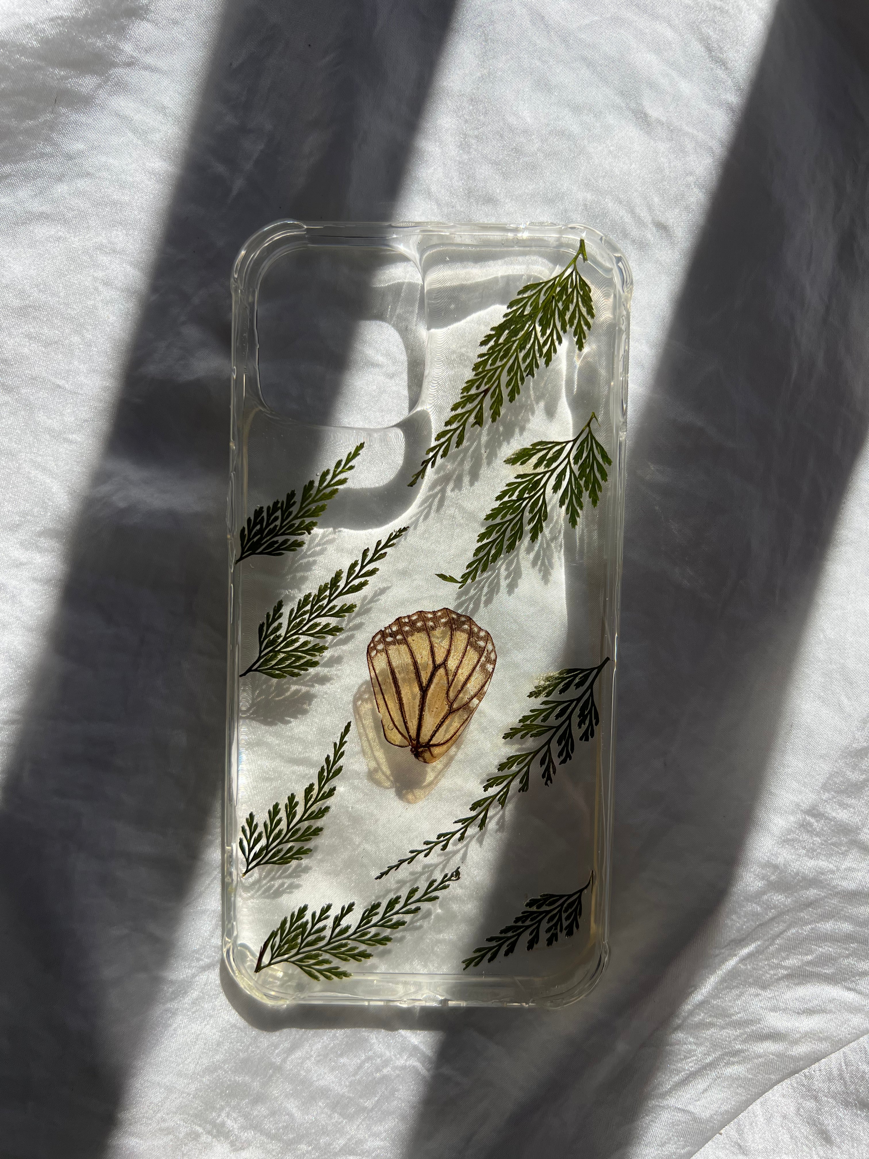 pressed flower phone case, botanical phone case, pressed flower art, handmade phone case, real pressed flowers, australian made, botanical art, pressed flower artist, floral art, botanical preservation, resin and flowers, flowers in resin, phone accessories, iphone 12 pro max, monarch butterfly wing, butterfly preservation, gold coast, tweed heads, byron bay, ferns